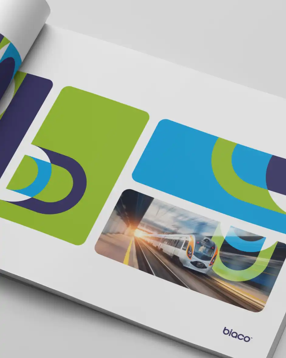 Open Biaco brand guideline book showing green and blue curved shapes with a high-speed train image.